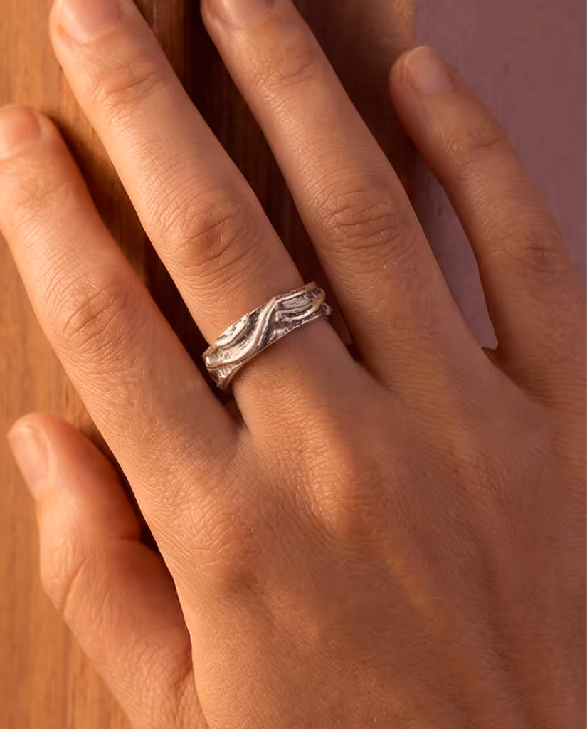 Finished sterling silver ring worn on finger