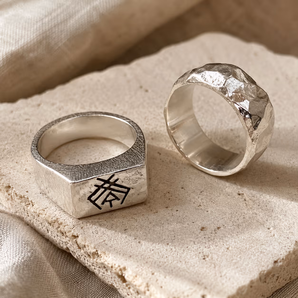 Stacked silver rings on stone